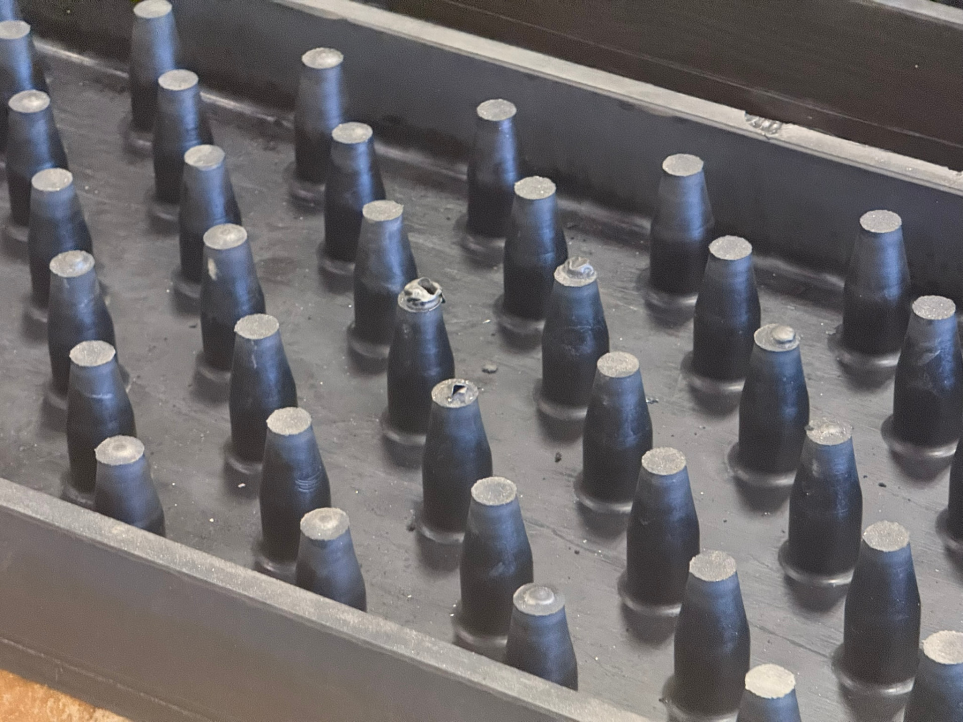 Conical nubs molded into a Cambelt belt curing mold