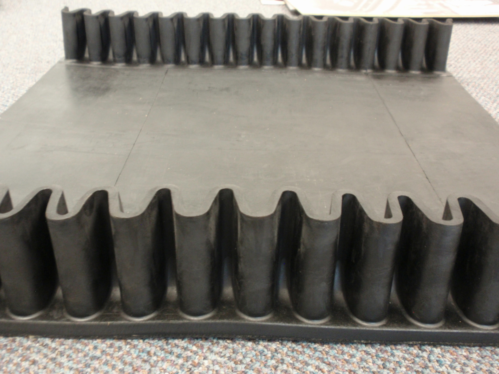 Corrugated sidewall profiles molded into a Cambelt belt panel