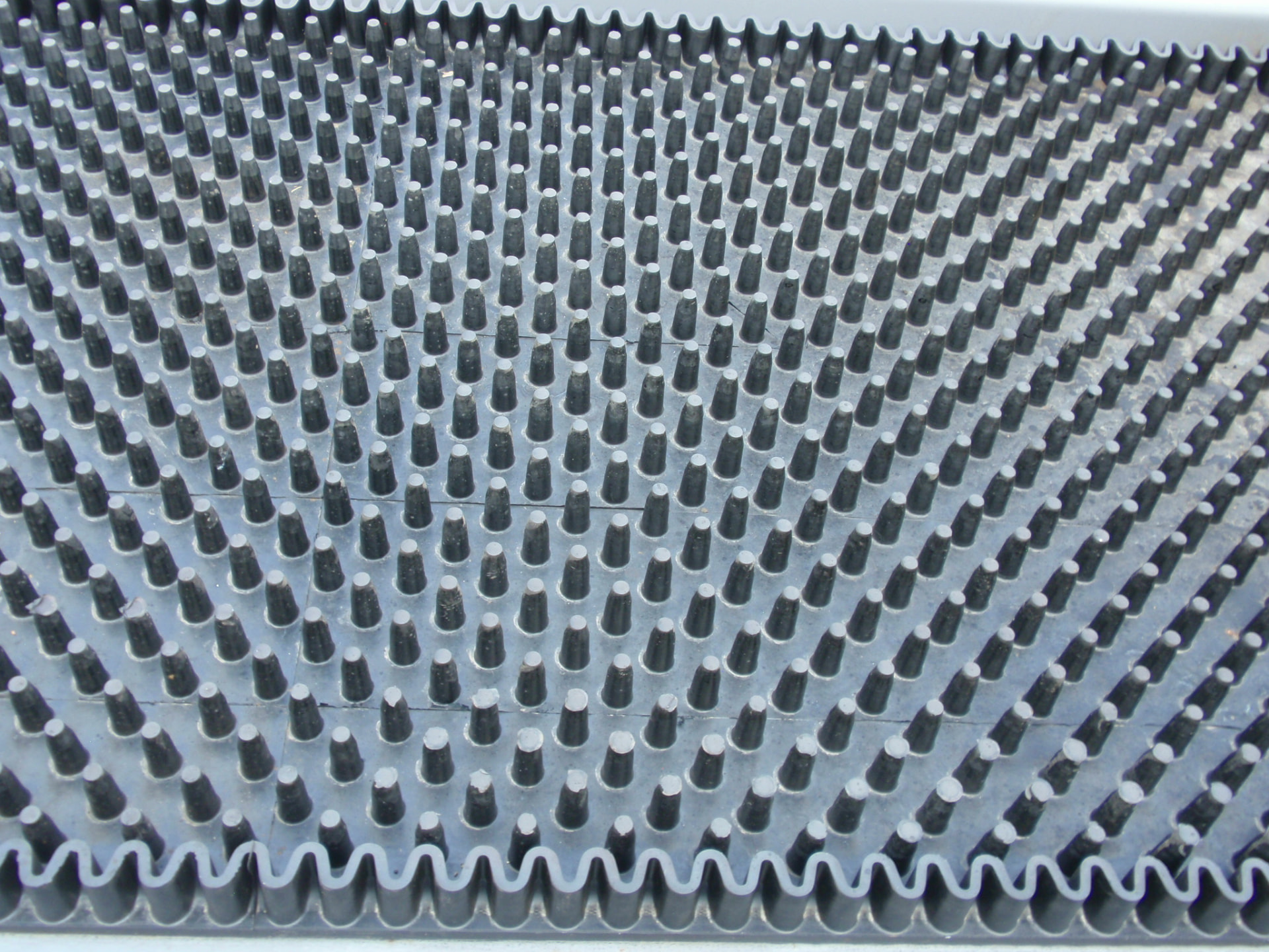 Close-up of Cambelt molded cleats, corrugated sidewall and reinforced belt surface