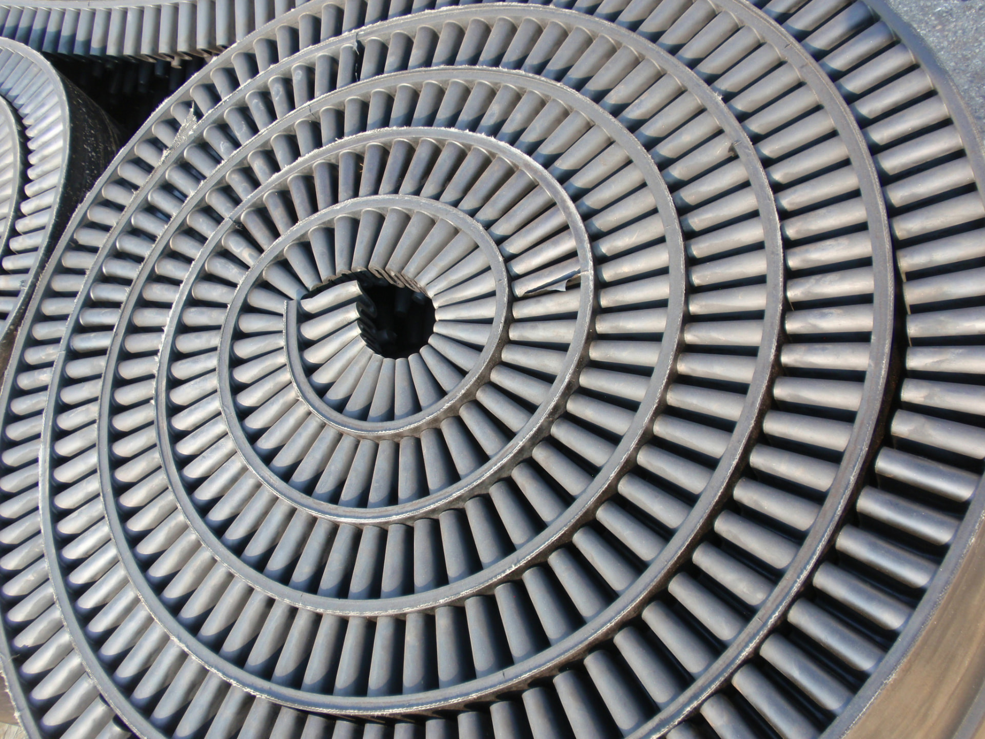A coiled one-piece molded belt, spiral-wound for shipment